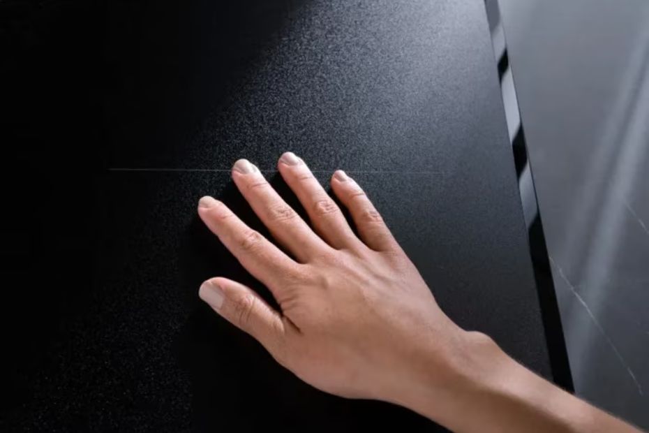 Hand auf der matten schwarzen Oberfläche eines AEG SaphirMatt Induktionskochfelds